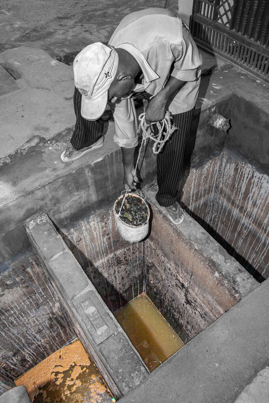 Fecal sludge being manually removed from a septic tank in a peri-urban house in Bareilly city, Uttar Pradesh